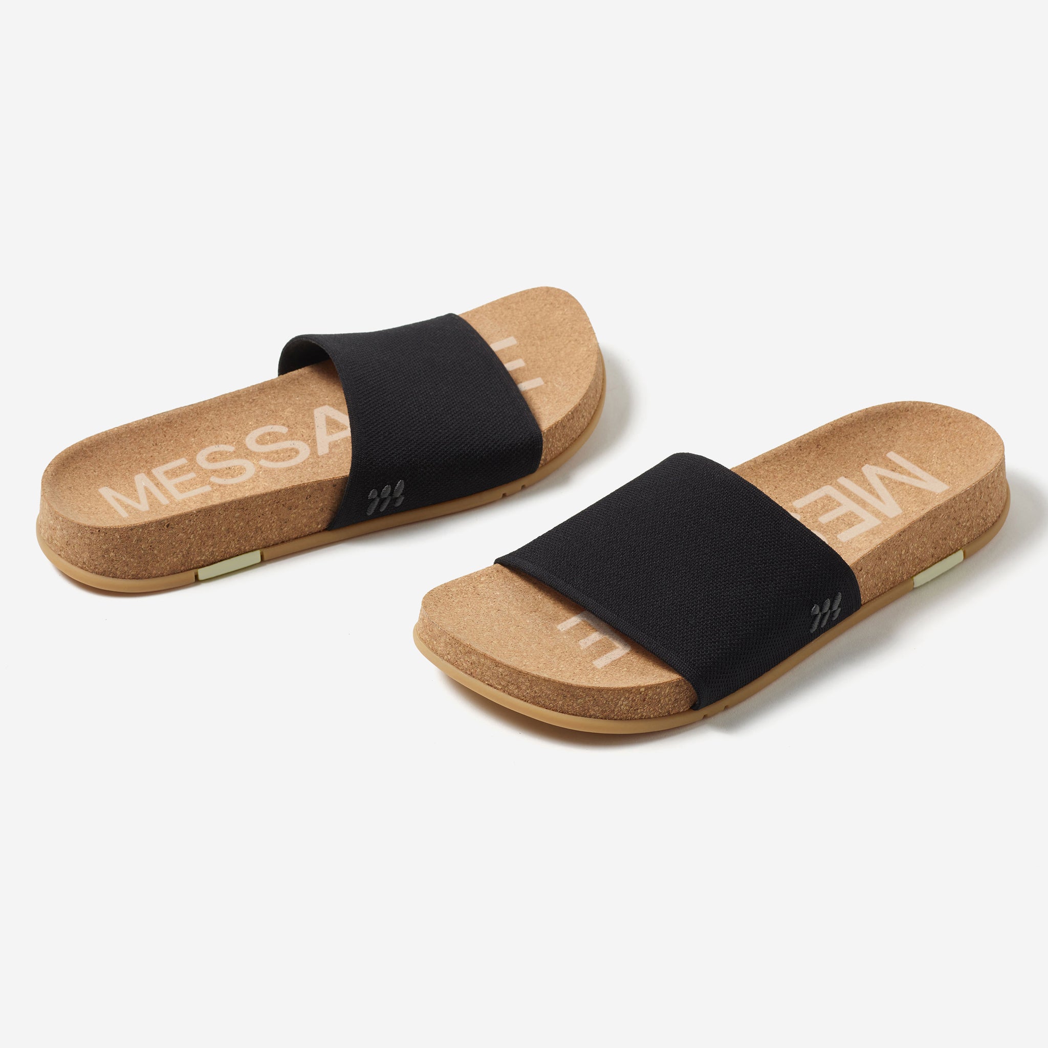 A pair of black MESSAGE Mullen slide sandals on a white background